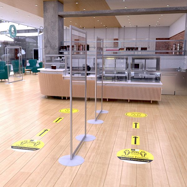 Clear acrylic modular protection screens sectioning the queing system in canteeen