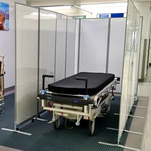 Dry wipe portable room dividers with a concertina design, used to create temporary medical treatment space