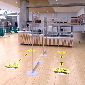 Clear acrylic modular protection screens sectioning the queing system in canteeen